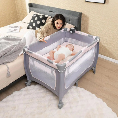Portable Baby Playard with Bassinet, Cradle, Toys, Diaper Storage, and Changing Station in Pink