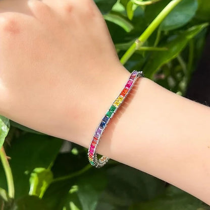 A dazzling 14K gold tennis bracelet adorned with rainbow-shaped cubic zirconia, the perfect gift for special occasions.