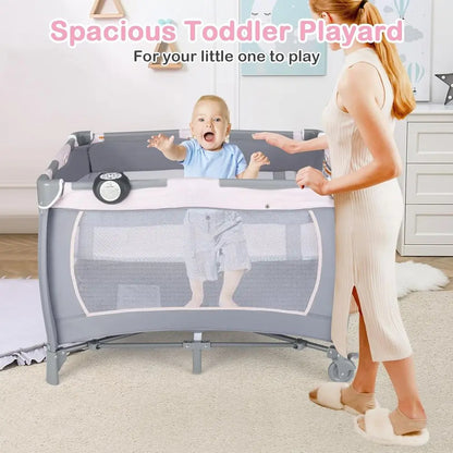 Portable Baby Playard with Bassinet, Cradle, Toys, Diaper Storage, and Changing Station in Pink