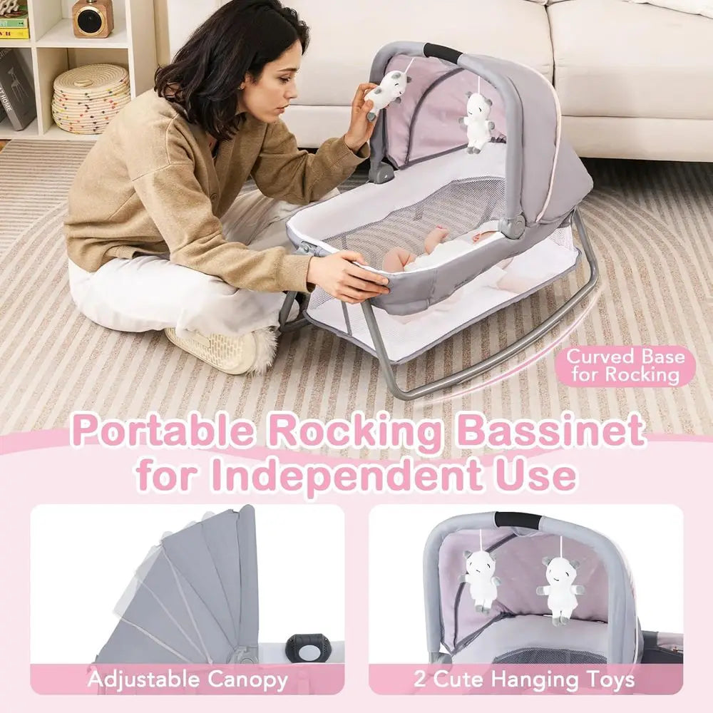 Portable Baby Playard with Bassinet, Cradle, Toys, Diaper Storage, and Changing Station in Pink