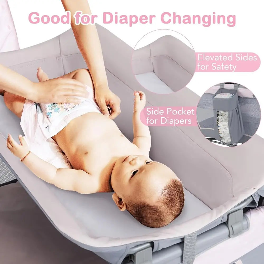 Portable Baby Playard with Bassinet, Cradle, Toys, Diaper Storage, and Changing Station in Pink
